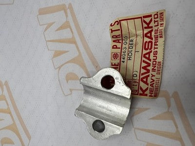 NOS OEM KAWASAKI FORK AXLE HOLDER F11     44063-005
