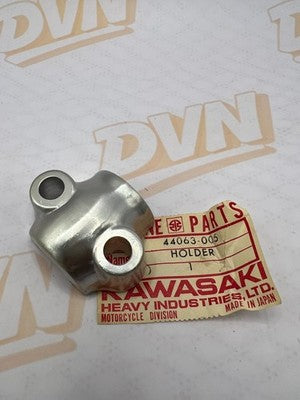 NOS OEM KAWASAKI FORK AXLE HOLDER F11     44063-005