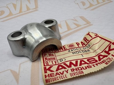 NOS OEM KAWASAKI FORK AXLE HOLDER F11     44063-005